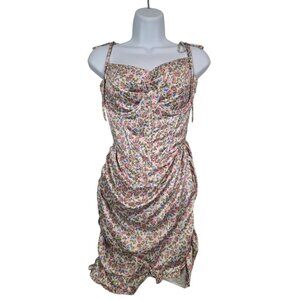 Mini dress with orange floral pattern and bow at the waist